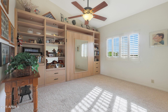 interior space featuring light carpet, vaulted ceiling, and ceiling fan