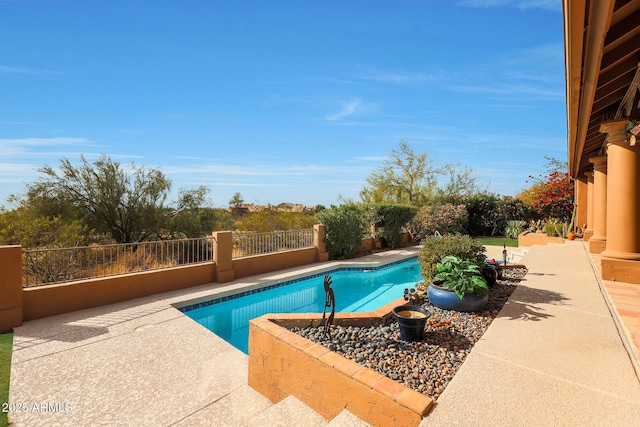 view of swimming pool with a patio area