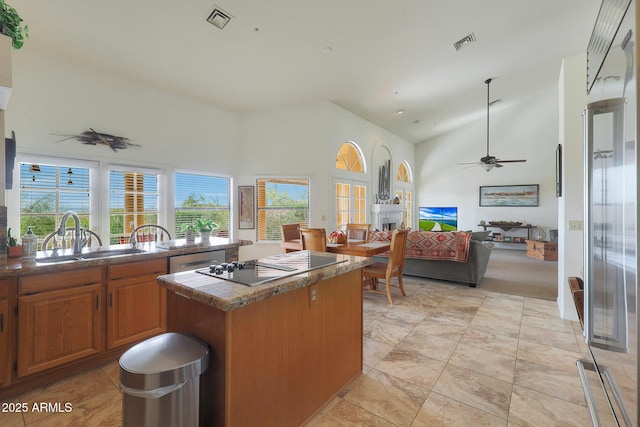 kitchen featuring dishwasher, high vaulted ceiling, sink, ceiling fan, and a kitchen island