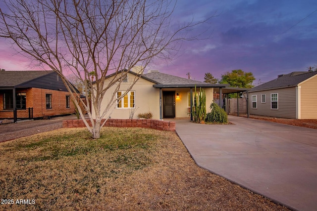 view of front of property with a yard and a carport