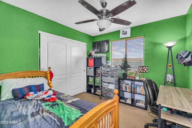 carpeted bedroom with a closet and ceiling fan