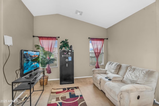 living room featuring lofted ceiling, a healthy amount of sunlight, visible vents, and carpet floors