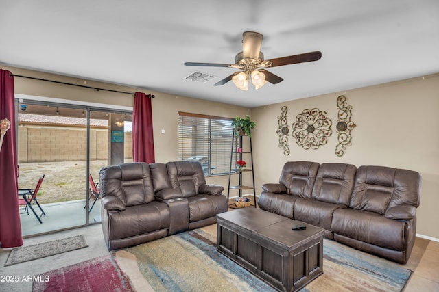 living area featuring visible vents, baseboards, and a ceiling fan