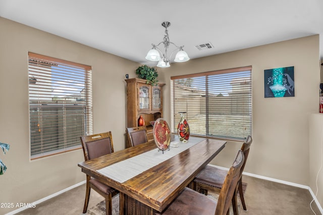 dining room featuring visible vents, baseboards, a chandelier, and carpet flooring