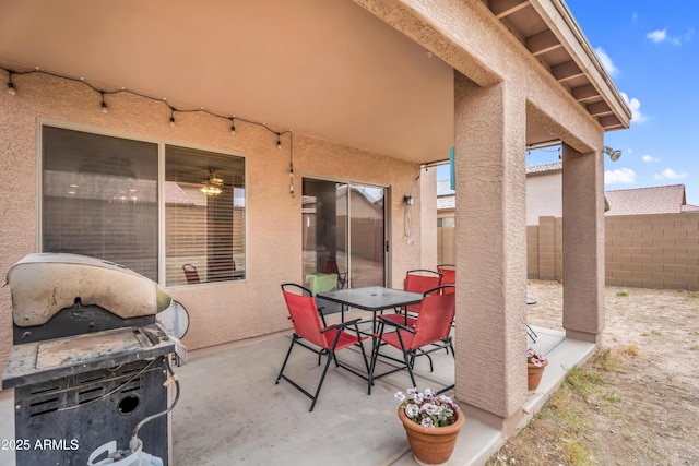 view of patio / terrace with grilling area, outdoor dining area, and fence