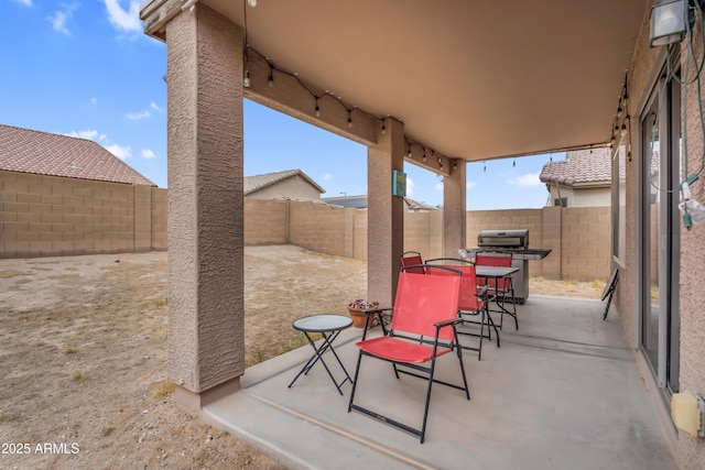 view of patio / terrace featuring area for grilling and a fenced backyard