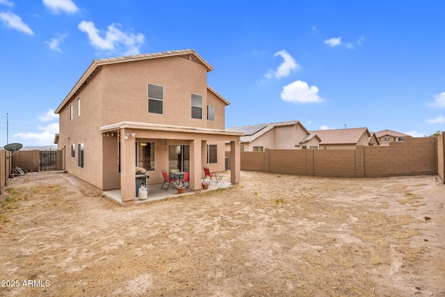 back of property featuring stucco siding, a patio, and a fenced backyard