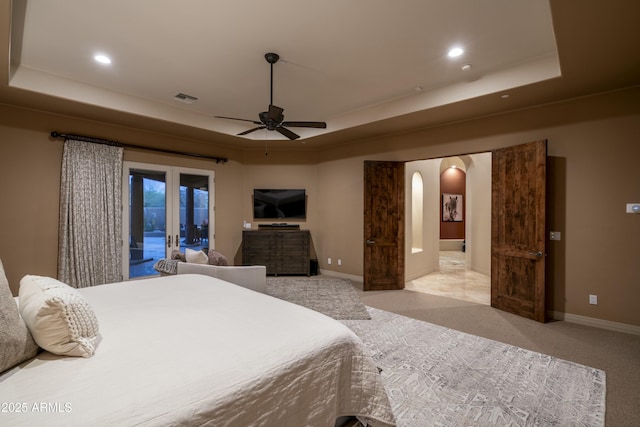 25031 N Paso Trl, Scottsdale, AZ 85255 - bedroom featuring arched walkways, a tray ceiling, and access to outside