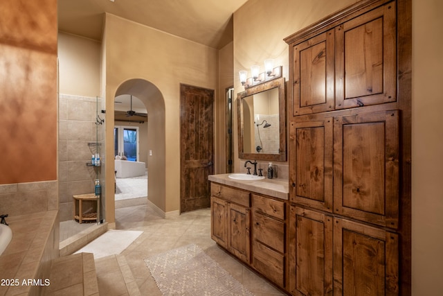 25031 N Paso Trl, Scottsdale, AZ 85255 - bathroom with baseboards, tiled shower, vanity, and tiled tub
