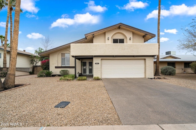 8414 E Stella Ln, Scottsdale, AZ 85250 - view of front of property featuring french doors, driveway, stucco siding, and an attached garage