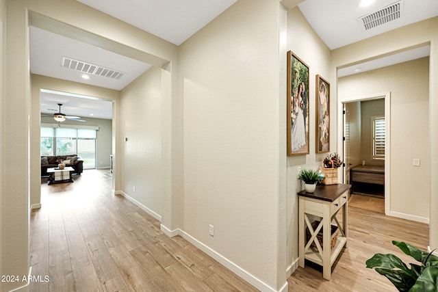 hallway with light hardwood / wood-style flooring