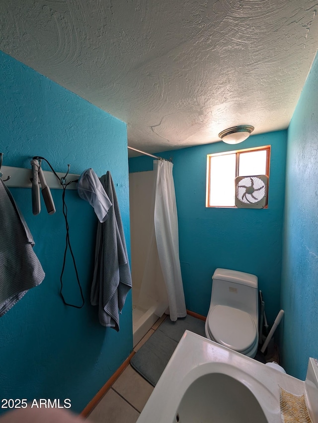 3827 N 8th St, Phoenix, AZ 85014 - bathroom featuring a shower stall, a textured ceiling, a textured wall, tile patterned floors, and toilet