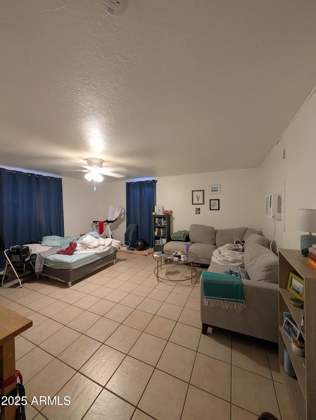 3827 N 8th St, Phoenix, AZ 85014 - bedroom with light tile patterned floors, ceiling fan, a textured ceiling, and a wall unit AC