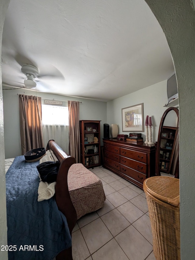3827 N 8th St, Phoenix, AZ 85014 - bedroom with light tile patterned floors, ceiling fan, and arched walkways