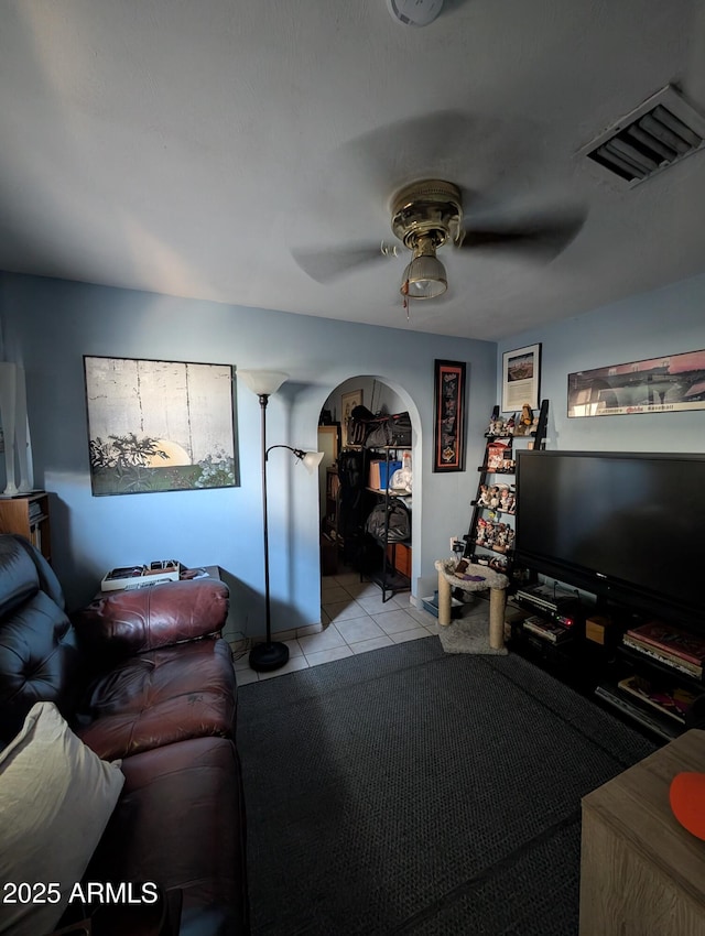 3827 N 8th St, Phoenix, AZ 85014 - living room featuring arched walkways, a ceiling fan, and tile patterned flooring