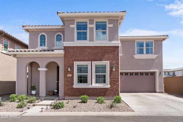 655 S Jacana Ln, Gilbert, AZ 85296 - view of front of property with concrete driveway, an attached garage, stucco siding, a tile roof, and brick siding