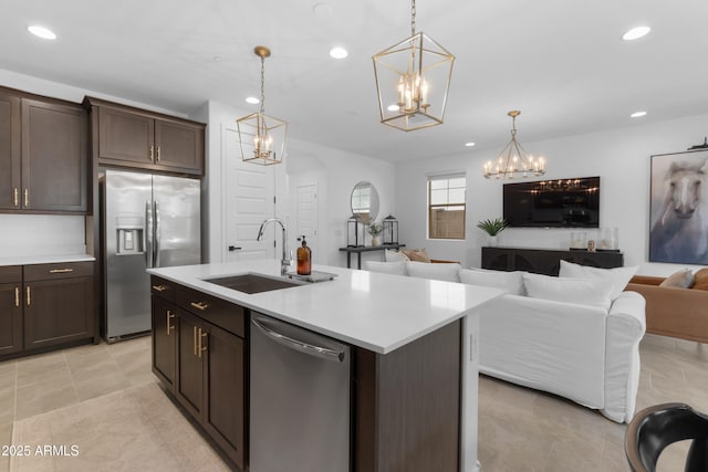 655 S Jacana Ln, Gilbert, AZ 85296 - kitchen with stainless steel appliances, a chandelier, a sink, open floor plan, and recessed lighting