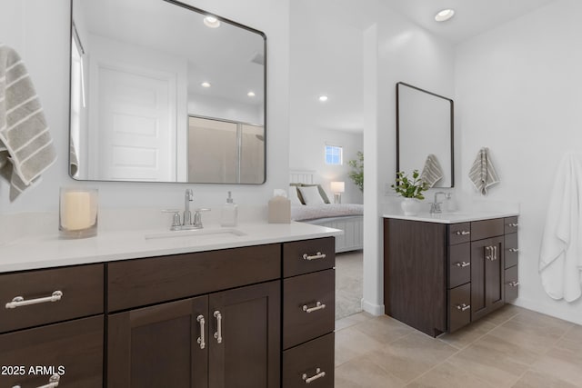 655 S Jacana Ln, Gilbert, AZ 85296 - full bathroom with two vanities, a shower stall, recessed lighting, tile patterned floors, and baseboards