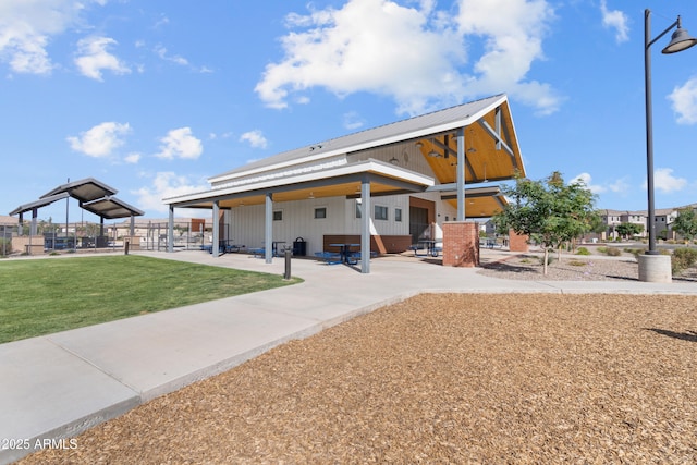 655 S Jacana Ln, Gilbert, AZ 85296 - back of property with a patio area, a yard, and metal roof
