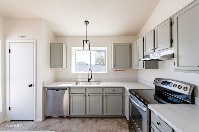 kitchen featuring gray cabinetry, decorative light fixtures, sink, and stainless steel appliances