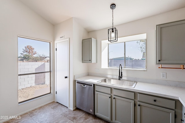 kitchen featuring stainless steel dishwasher, sink, decorative light fixtures, gray cabinets, and lofted ceiling