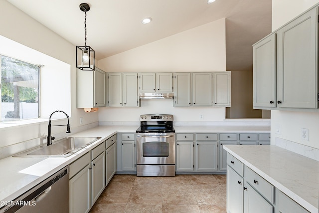 kitchen with appliances with stainless steel finishes, sink, gray cabinets, hanging light fixtures, and lofted ceiling