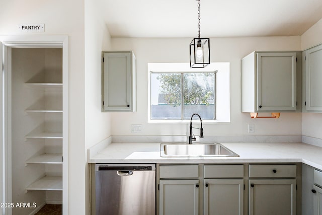 kitchen with stainless steel dishwasher, pendant lighting, gray cabinetry, and sink