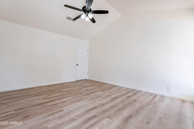 spare room with light wood-type flooring, vaulted ceiling, and ceiling fan