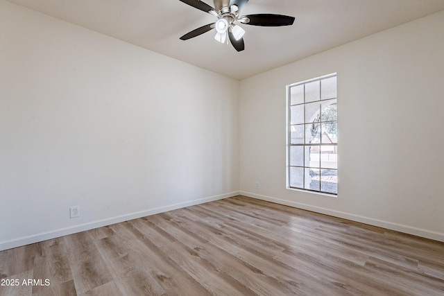 spare room featuring light wood-type flooring and ceiling fan