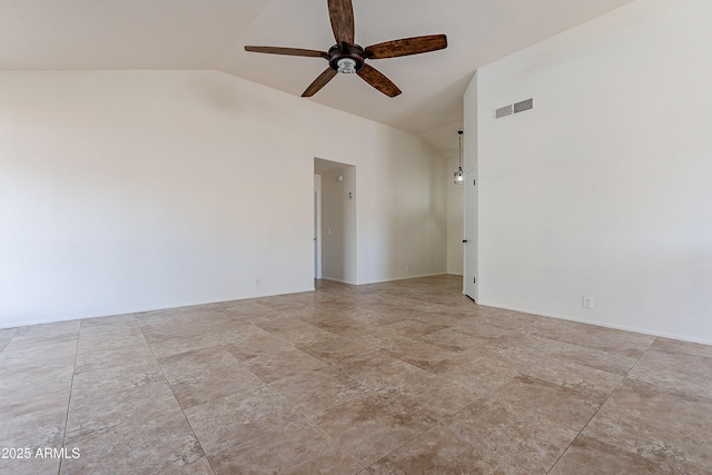 empty room with ceiling fan and vaulted ceiling