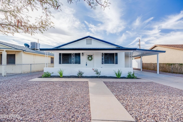 ranch-style home featuring a carport and cooling unit