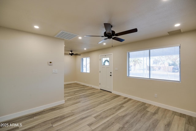 entrance foyer with ceiling fan and light wood-type flooring