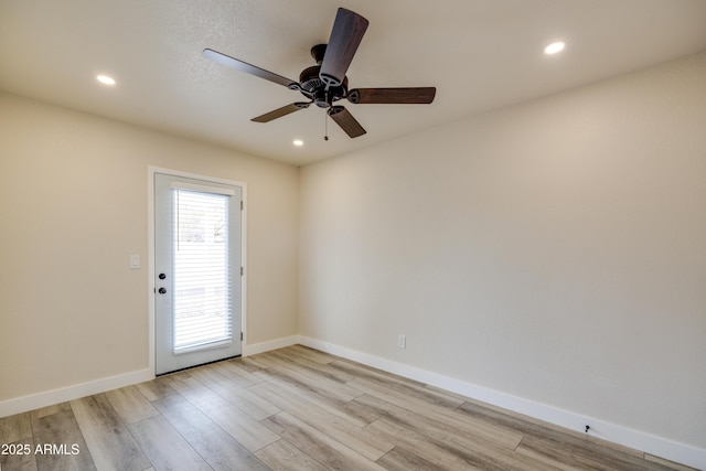 empty room featuring light hardwood / wood-style flooring and ceiling fan