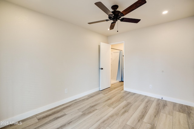 unfurnished room featuring ceiling fan and light wood-type flooring