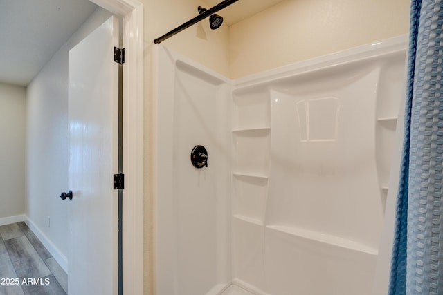 bathroom featuring walk in shower and wood-type flooring