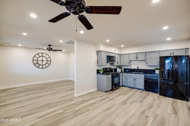 kitchen with gray cabinets, sink, light hardwood / wood-style floors, and black appliances