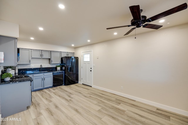 kitchen featuring sink, gray cabinets, ceiling fan, black appliances, and light wood-type flooring