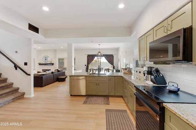 kitchen featuring tasteful backsplash, black range with electric cooktop, light wood-type flooring, a peninsula, and stainless steel dishwasher