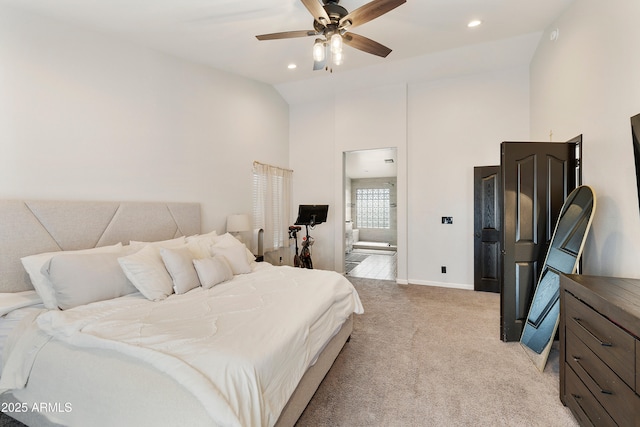 bedroom with high vaulted ceiling, recessed lighting, ensuite bathroom, and light carpet