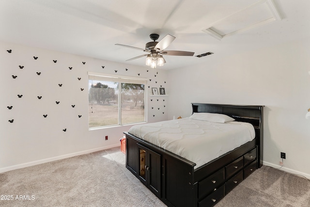 bedroom with baseboards, light colored carpet, attic access, and a ceiling fan