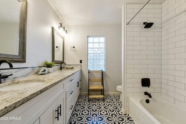 full bath featuring tile patterned floors, double vanity, toilet, and a sink