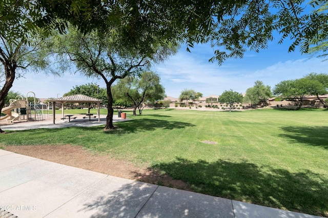 view of community with a gazebo, playground community, and a lawn