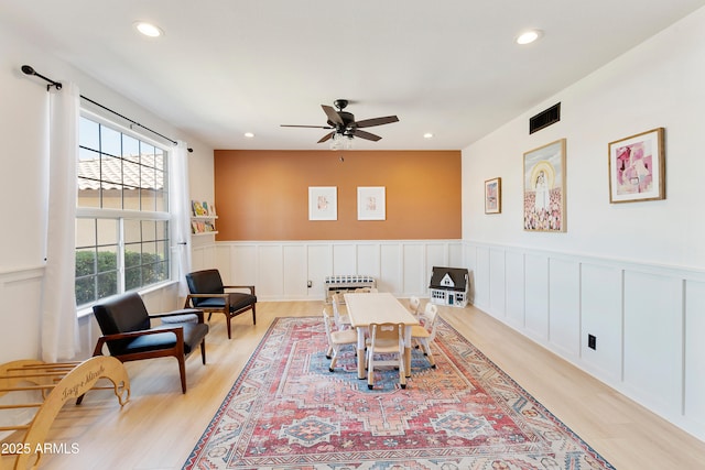 recreation room with recessed lighting, visible vents, light wood-style flooring, and wainscoting