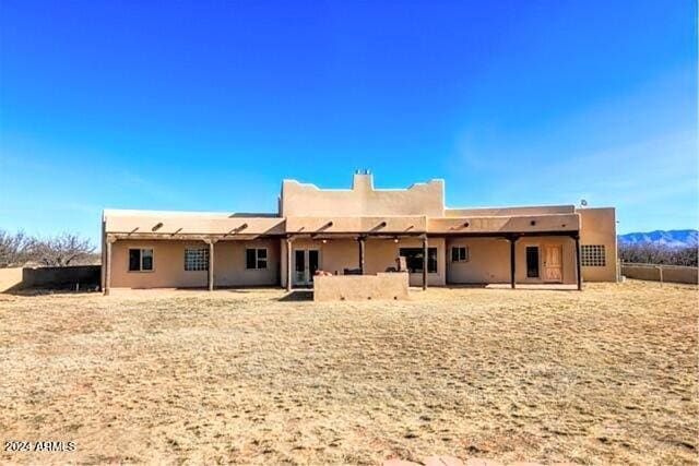 back of house featuring stucco siding, fence, and a patio
