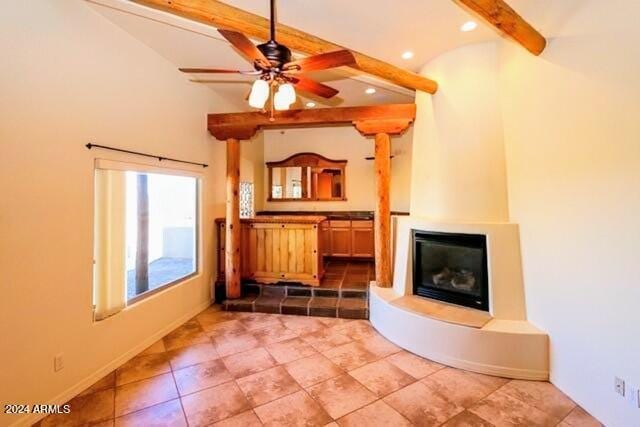 unfurnished living room with beamed ceiling, baseboards, ceiling fan, recessed lighting, and a glass covered fireplace