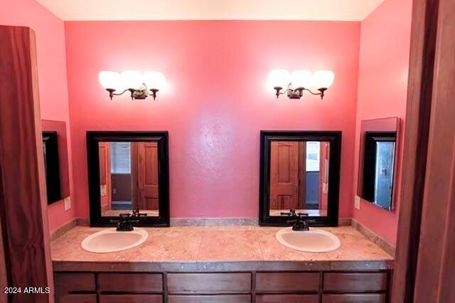 full bath with a stall shower, baseboards, toilet, and vanity