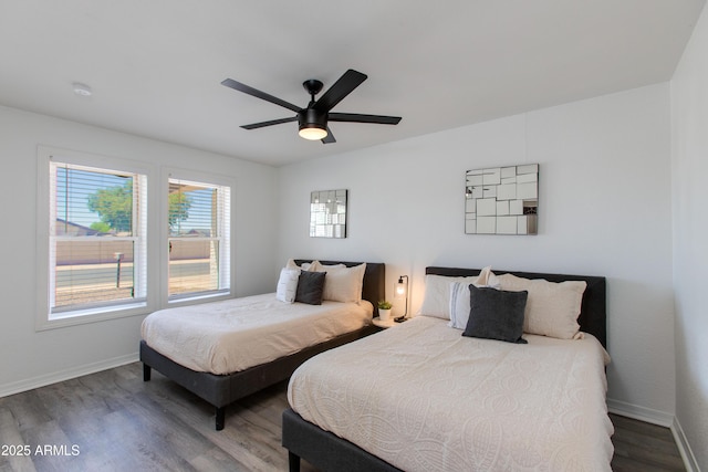 bedroom with baseboards, wood finished floors, and a ceiling fan