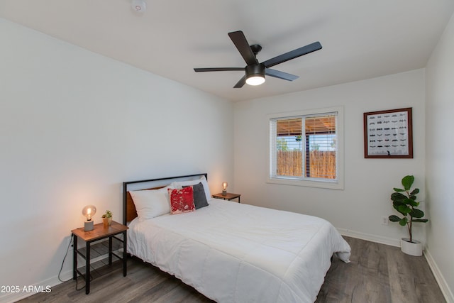 bedroom featuring wood finished floors, baseboards, and ceiling fan