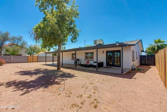 back of house featuring french doors, a patio area, a fenced backyard, and central AC unit
