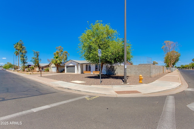 view of front of property featuring fence and an attached garage